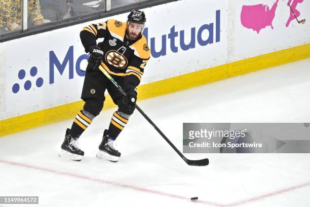 Boston Bruins defenseman John Moore passes the puck across the ice to an open teammate. During Game 7 of the Stanley Cup Finals featuring the Boston...