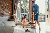 little girl help her daddy to do chores