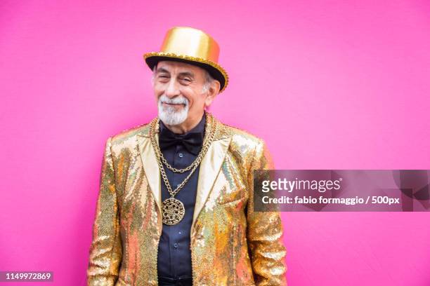 eccentric senior man portrait - gold jacket stock pictures, royalty-free photos & images