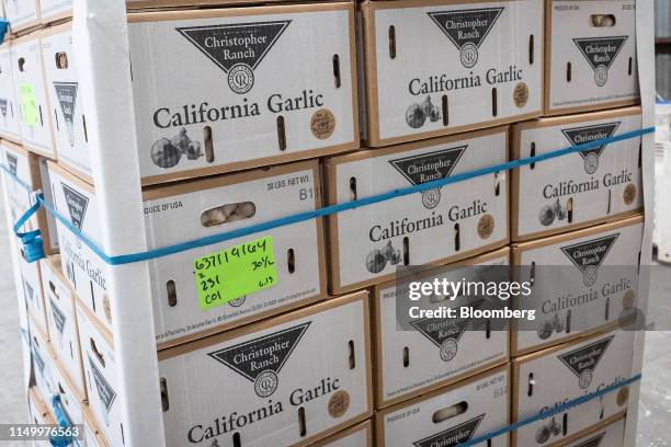 Boxes of garlic sit stacked on a pallet at the Christopher Ranch in Gilroy, California, U.S., on Thursday, June 13, 2019. Gilroy, California, known...