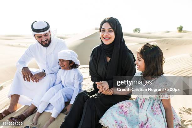 happy family spending a wonderful day in the desert making a pic - daily life in abu dhabi stock pictures, royalty-free photos & images