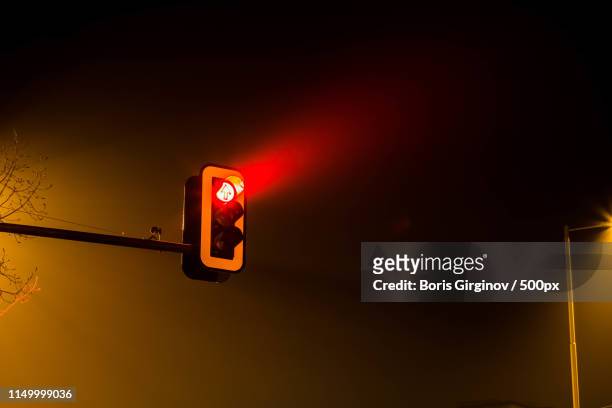 traffic lights by night - red light stock pictures, royalty-free photos & images