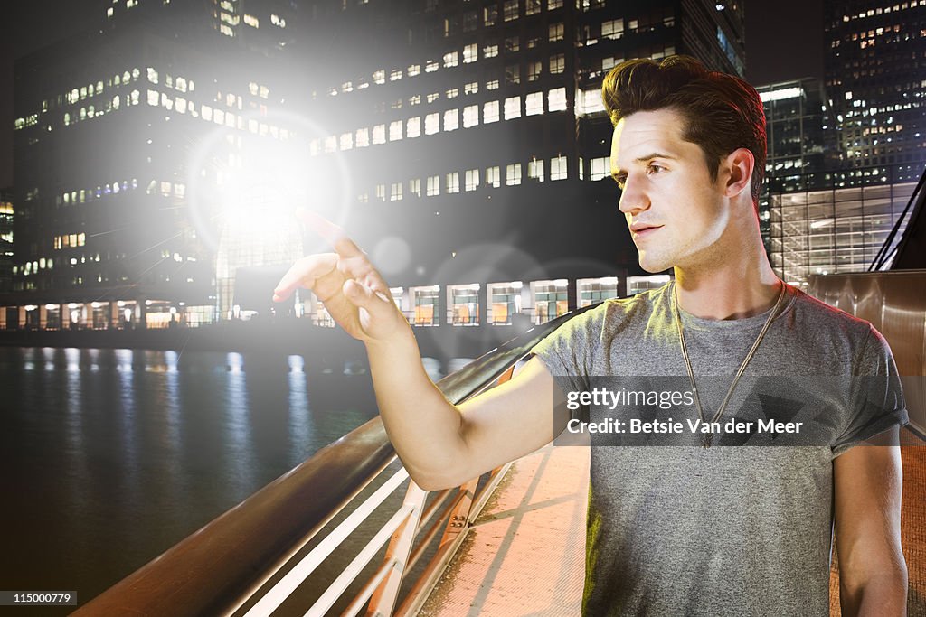 Man touches ball of light flloating in sky.