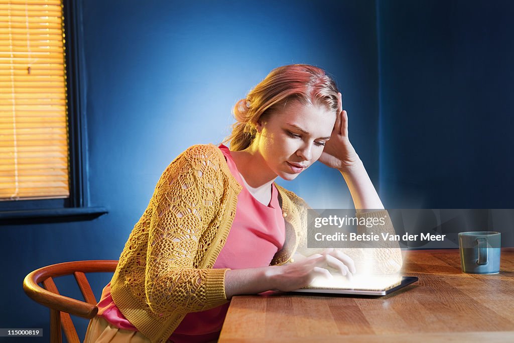 Woman searching on digital tablet.