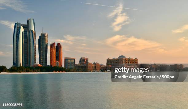 view of abu dhabi skyline at sunset, uae - abu dhabi sunrise stock pictures, royalty-free photos & images