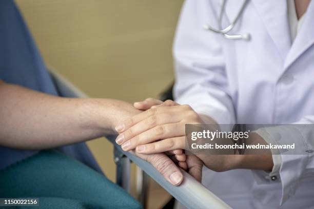 doctor holding patient's hand, helping hand concept - ethical treatment stock pictures, royalty-free photos & images