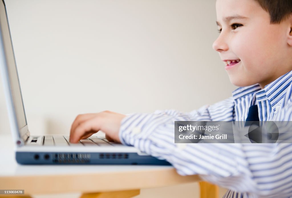 Young boy using laptop computer