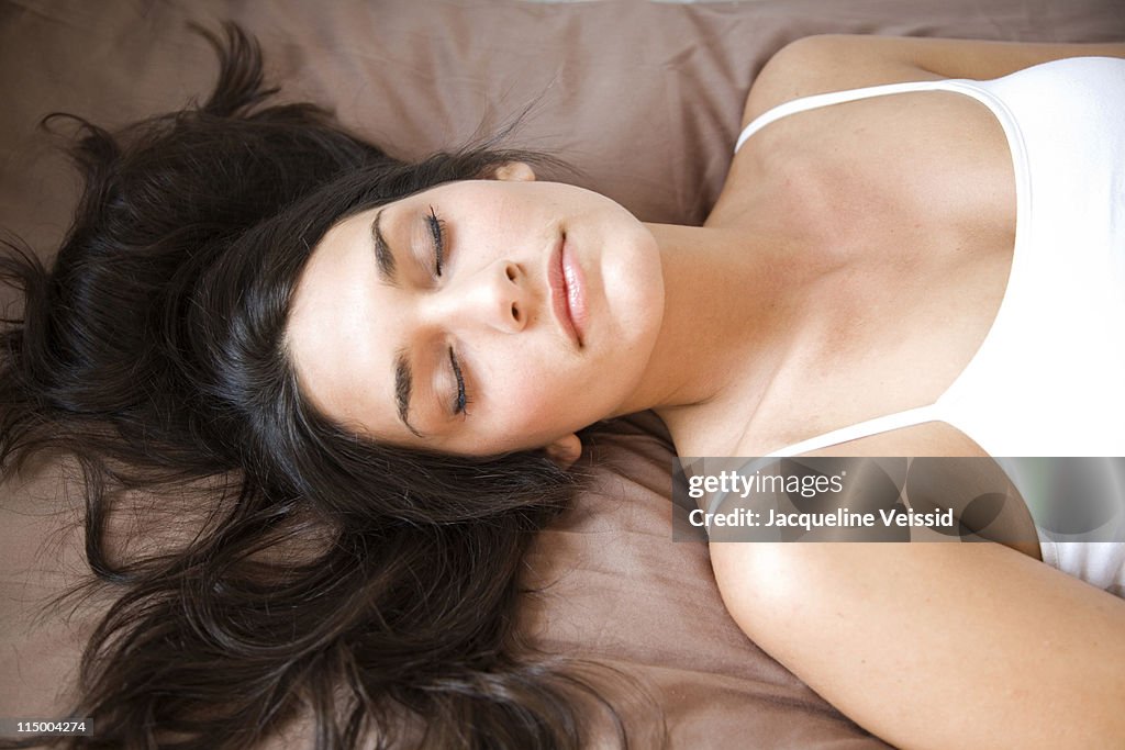 Woman with dark long hair sleeping