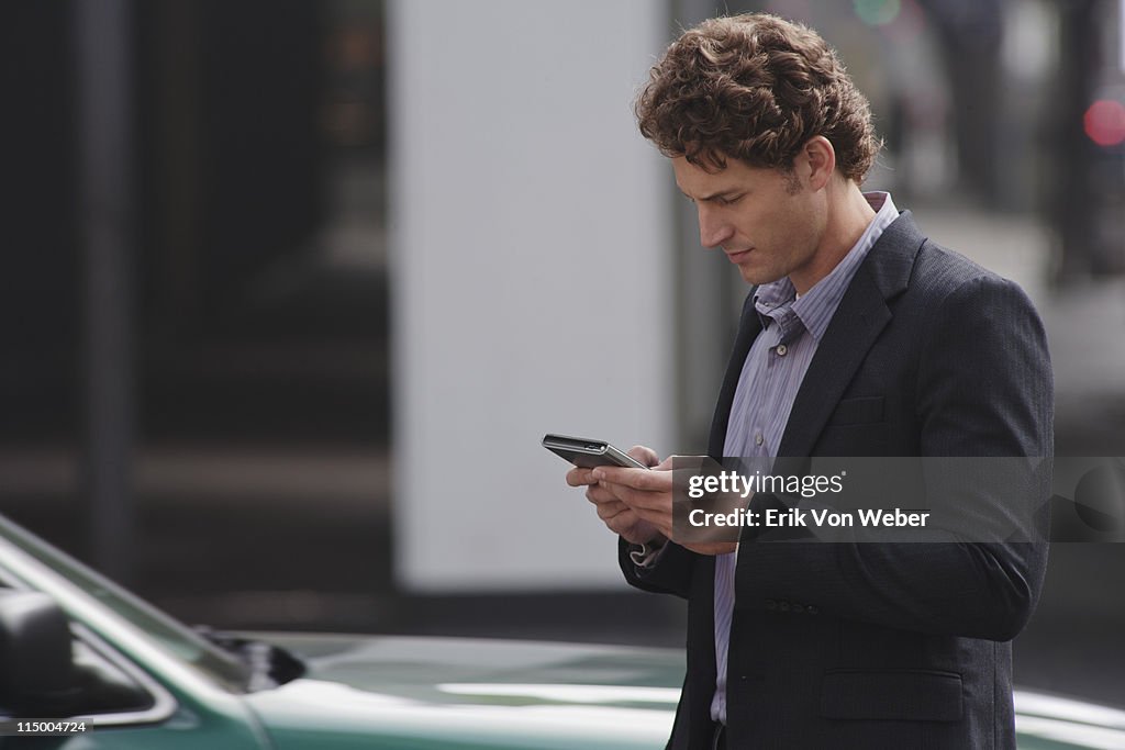 Man holding a smartphone in the street