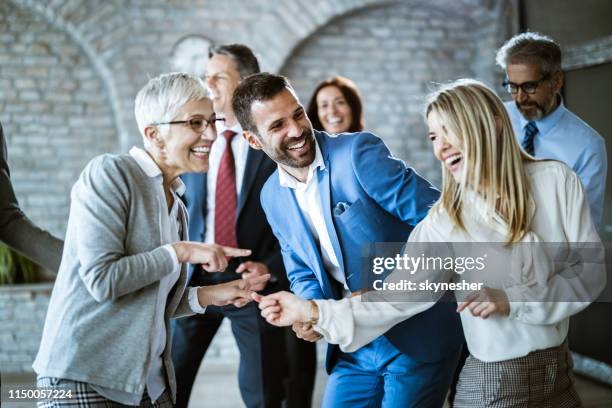 happy business colleagues having fun while dancing in the office. - corporate party stock pictures, royalty-free photos & images