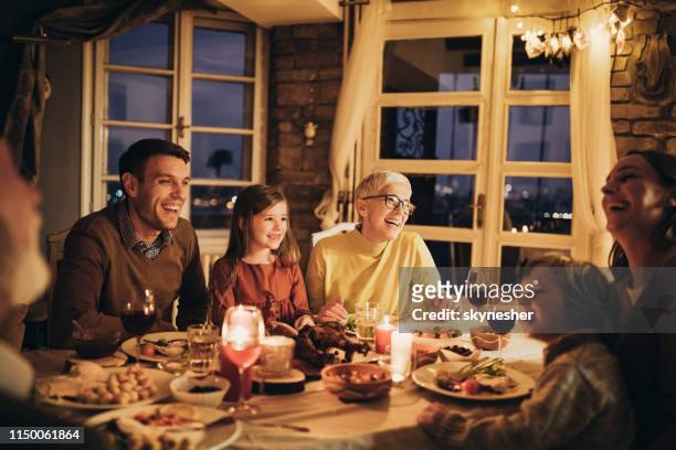 cheerful multi-generation family talking during dinner at home. - evening meal stock pictures, royalty-free photos & images