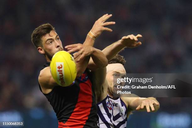 Kyle Langford of the Bombers competes in the air with Joel Hamling of the Dockers during the round nine AFL match between the Essendon Bombers and...