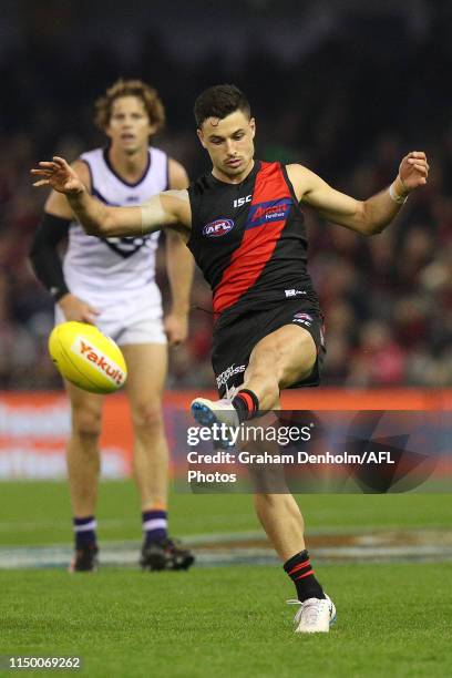 Ben McNiece of the Bombers kicks during the round nine AFL match between the Essendon Bombers and the Fremantle Dockers at Marvel Stadium on May 18,...