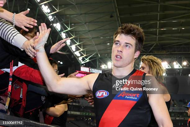 Zach Merrett of the Bombers high fives fans after winning the round nine AFL match between the Essendon Bombers and the Fremantle Dockers at Marvel...