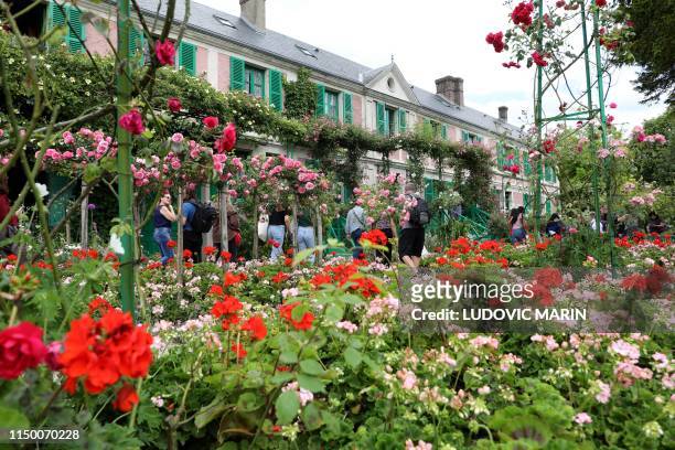 People visit the gardens during a tour at the Claude Monet house and foundation, on june 14 in Giverny.