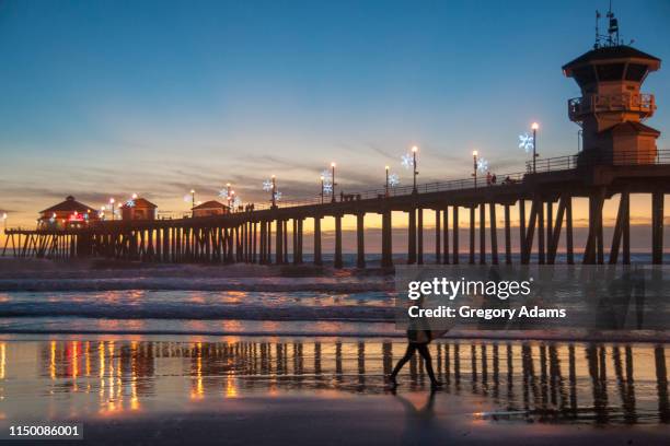 huntington beach pier at sunset - huntington beach stock pictures, royalty-free photos & images