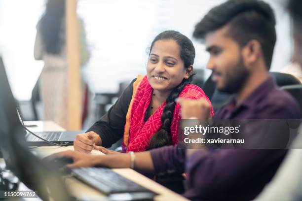 male and female colleagues planning at office desk - people of india stock pictures, royalty-free photos & images