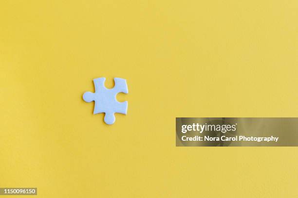 jigsaw puzzle piece on yellow backgrounds - connect the dots puzzle stock pictures, royalty-free photos & images