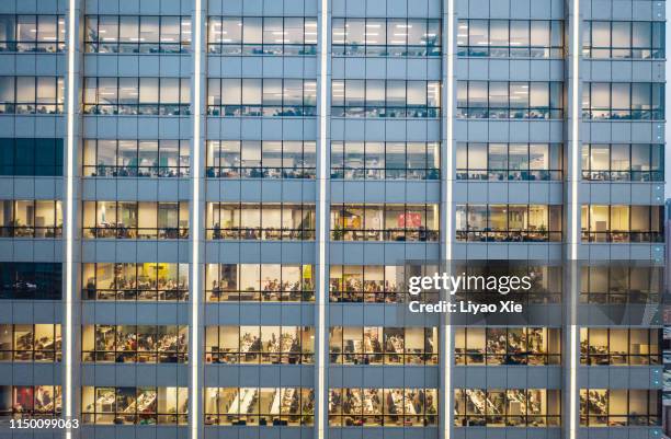 working late in the office - facade works stock pictures, royalty-free photos & images