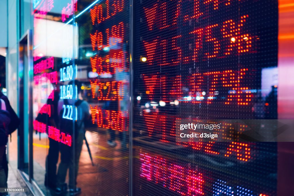 Stock exchange market display screen board on the street showing stock market crash sell-off in red colour