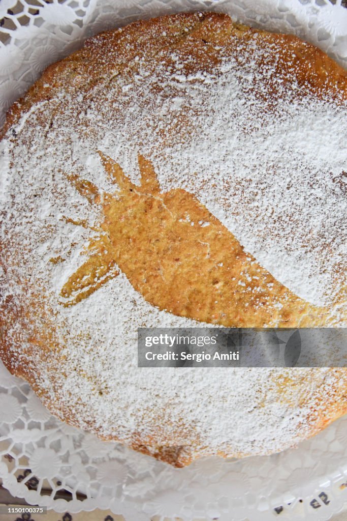 Carrot cake with icing sugar and carrot shape