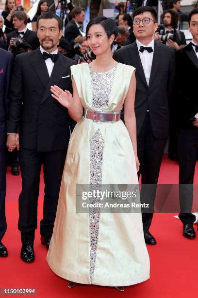 Liao Fan, Gwei Lun-Mei and Director Diao Yinan depart the screening of "The Wild Goose Lake " during the 72nd annual Cannes Film Festival on May 18,...