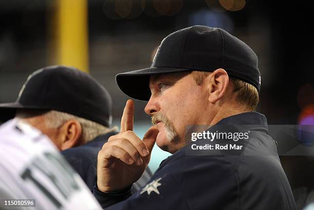 Eric Wedge, manager of the Seattle Mariners signals during the game against the Baltimore Orioles at Safeco Field on June 1, 2011 in Seattle,...