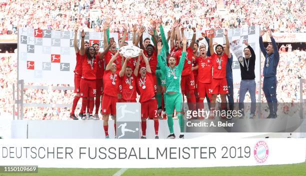 The team of FC Bayern celebrate the German Championship title after the Bundesliga match between FC Bayern Muenchen and Eintracht Frankfurt at...