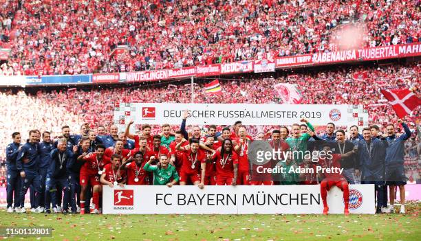 Arjen Robben of Bayern Munich and team mates celebrate with the trophy following the Bundesliga match between FC Bayern Muenchen and Eintracht...