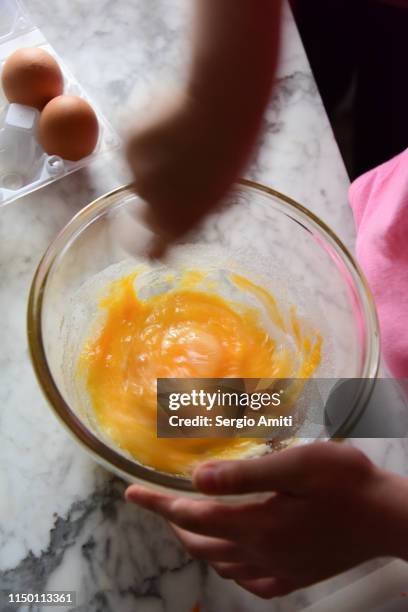 mixing the ingredients for a carrot cake in a glass bowl - cake bowl stock pictures, royalty-free photos & images