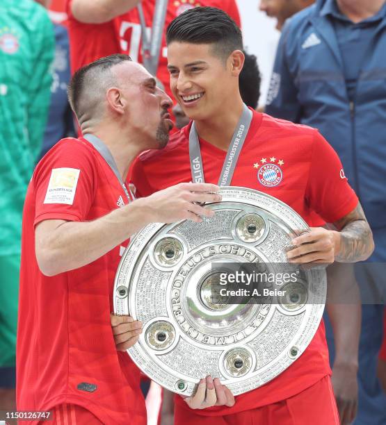 James Rodriguez and Franck Ribery of FC Bayern Muenchen celebrate the German Championship title after the Bundesliga match between FC Bayern Muenchen...