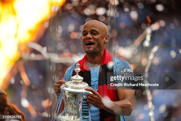Vincent Kompany of Manchester City lifts the trophy following the FA Cup Final match between Manchester City and Watford at Wembley Stadium on May...