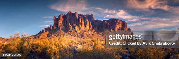 panoramic view of superstition mountain near barren lands of phoenix - superstition mountains fotografías e imágenes de stock
