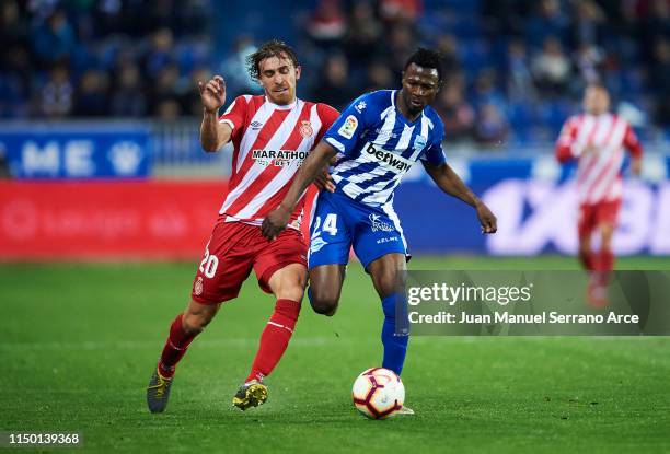 Patrick Twumasi of Deportivo Alaves duels for the ball with Marc Muniesa of Girona FC during the La Liga match between Deportivo Alaves and Girona FC...
