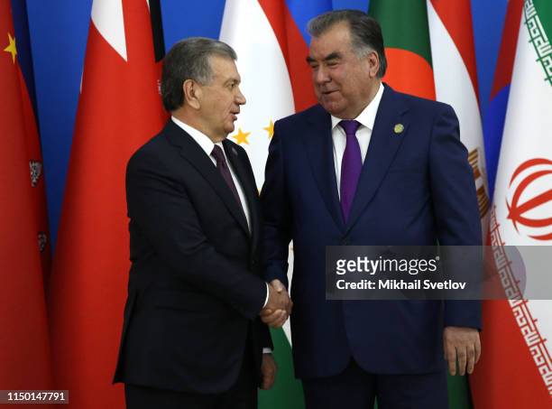 Tajik President Emomali Rakhmon greets Uzbek President Shavkat Mirziyoyev during the 5th Summit of the Conference on Interaction and...