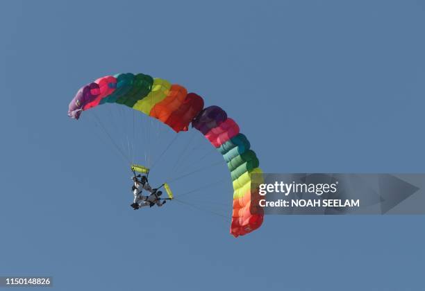 Members of Indian Air Force sky diving team perform during a combined graduation parade during the Combined Graduation Parade at the Indian Air Force...