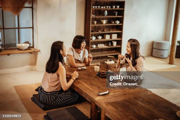 young taiwanese women drinking tea and eating cake in restaurant. - ladies night stock pictures, royalty-free photos & images