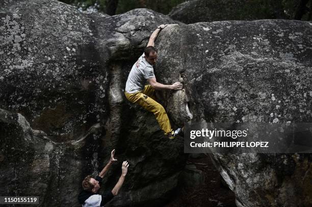 French climber Jeremy Bonder is assisted by fellow climber Jacky Godoff , as he demonstrates his skills at bouldering -a form of rock climbing that...