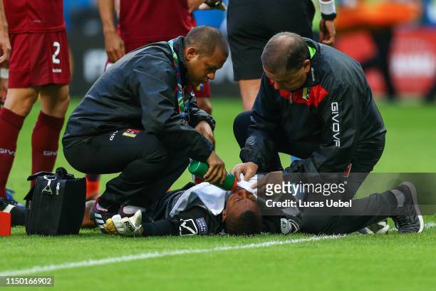 Wuilker Faríñez of Venezuela receives medical attention after an injury during the Copa America Brazil 2019 Group A match between Venezuela and Peru...