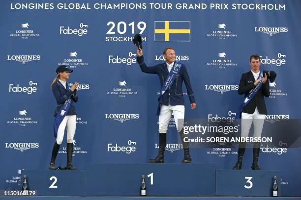 Second placed Malin Baryard-Johnsson of Sweden, winner Peder Fredricson of Sweden and third placed Jos Verlooy of Belgium celebrate on the podium...