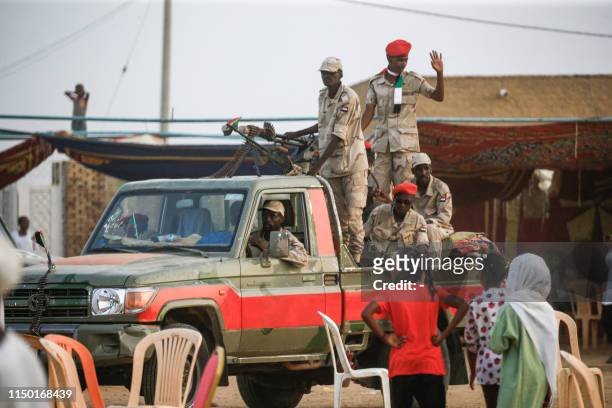 Members of Sudan's Rapid Support Forces paramilitaries speak to girls from atop a technical during a rally in the village of Qarri, about 90...
