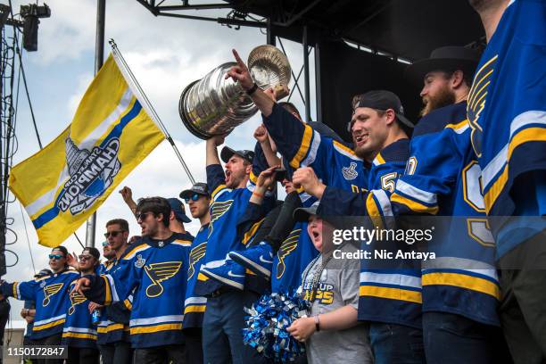 Alex Pietrangelo of the St. Louis Blues hoist the Stanley Cup while celebrating with his teammates during the St Louis Blues Victory Parade and Rally...