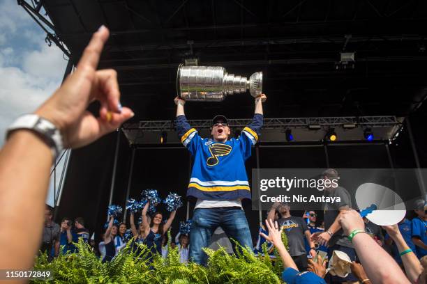 Colton Parayko of the St. Louis Blues hoists the Stanley Cup during the St Louis Blues Victory Parade and Rally after winning the 2019 Stanley Cup...