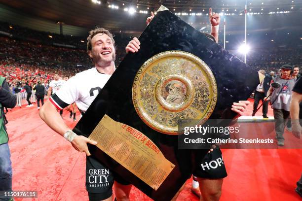 Maxime Medard of Stade Toulousain carries the Bouclier de Brennus and celebrates the victory of the Top 14 Final match between Toulouse and Clermont...