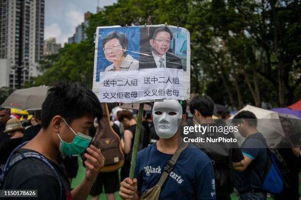 Man is seen holding up a sign which has Hong Kong's Chief Executive Carrie Lam and Secretary for Security John Lee photo on it in Hong Kong, China....