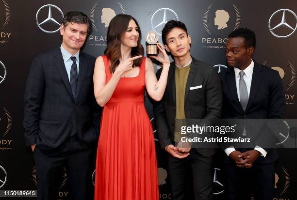 Michael Schur, D'Arcy Carden, Manny Jacinto and William Jackson Harper pose with the Peabody Award for The Good Place in the press room of 78th...