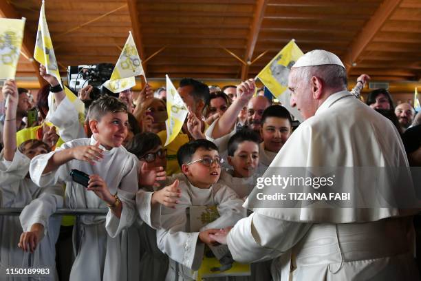 Pope Francis meets with boys who recently made their first communion, on June 16, 2019 at the Camerino sports hall as part of a visit to the areas...