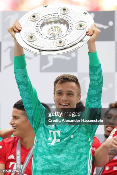 Christian Fruechtl of Bayern Munich lifts the trophy following the Bundesliga match between FC Bayern Muenchen and Eintracht Frankfurt at Allianz...