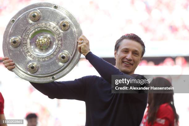 Niko Kovac, Manager of Bayern Munich lifts the trophy following the Bundesliga match between FC Bayern Muenchen and Eintracht Frankfurt at Allianz...