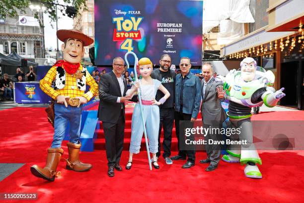 Mark Nielsen, Josh Cooley, Tom Hanks and Jonas Rivera pose with characters from Toy Story at the European Premiere of "Toy Story 4" at Odeon Luxe...